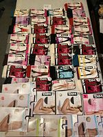 Array of new leggings and tights neatly displayed in original packaging, showing various colors and designs.