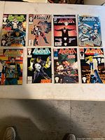 Eight The Punisher comic books laid out showing front covers with various Marvel Comics logos and titles
