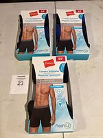 Three packages of Hanes Luxury Softness boxer briefs arranged with size Small/P and FreshIQ technology labeled.