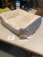 Photo of rectangular pet bed showing plush interior and patterned outer fabric.