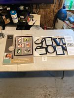 Lot laid out on table with boxed floating collage frame and LOVe multiple photo frame