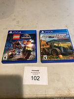 Two PS4 game cases side by side: LEGO Jurassic World and Professional Farmer.