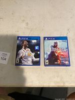 Photo of two PS4 game cases: FIFA 18 with inscription, Battlefield V, on a light-colored surface.