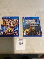 Two PS4 game cases on a gray surface. Left case labelled 'Carnival Games' with bright carnival themed artwork, right case labelled 'Professional Construction The Simulation' showing construction machinery.