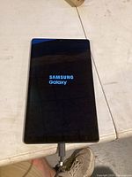 Samsung Galaxy tablet powered on showing Samsung Galaxy boot logo.