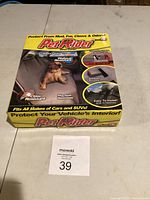 Front side of Pet Rider seat cover box showing branding, use case (protects from mud, fur, claws, and odors), and compatibility with all makes of cars and SUVs.