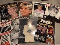 Photo showing seven magazines including Globe, Maclean's, Entertainment, Newsweek, People, and Diana tribute issues, along with the vintage fashion book by Alison Janaway featured prominently