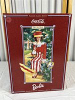 Front of the red box featuring vintage-style illustration of the Barbie doll in red and white striped dress, 'After the Walk', part of Coca-Cola Fashion Classic Series.