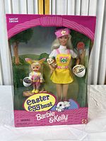 Full front view of Barbie & Kelly Easter Egg Hunt Gift Set in original pink box with Easter-themed graphics showing dolls and accessories.