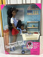 Frontal photo of boxed Barbie & Kelly Shoppin' Fun Playset including Barbie doll, Kelly doll in shopping cart, toy groceries and grocery store backdrop.