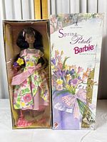 Front view of Spring Petals Barbie doll in original floral-themed box showing box damage and doll attire.