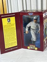 Front view of the figure in original box showing Ty Cobb in striped Detroit Tigers uniform and brand details.