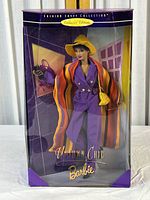 Photo of Uptown Chic Barbie doll fully dressed in original box with visible plastic cover and purple decorative background