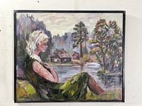 Frontal view of the oil painting showing the female figure seated beside a lake, rustic houses in the background, signed and dated on the canvas.