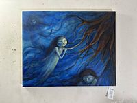 Full view of the oil painting showing ghostly female figures in blue tones with brown tree roots, unframed.