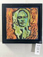 Front view of the square oil painting portrait with vivid green and orange coloration, framed in black.