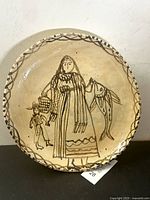 Full view of the hand-painted Mexican folk art platter showing the full design and scalloped edge with geometric brushwork.