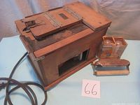 Wooden box-style Kodak Amateur printer with attached power cord and accompanying boxes of bulbs and metal accessory.