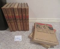 Six volumes stacked and two volumes laid flat showing the cover titled 'South Africa and the Transvaal War' by Louis Creswicke.