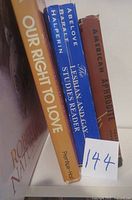 Spine view of three books showing titles and authors: Our Right to Love by Roberta Nave, The Lesbian and Gay Studies Reader by Abelove, Barale, Halperin, and American Aphrodite with worn red spine.