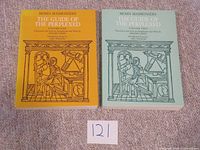 Front covers of both volumes, yellow Volume One and green Volume Two, showing title, author, translator, and publisher details.