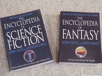 Both encyclopedia books shown side by side on carpet, front covers visible