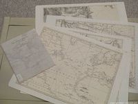 Photo showing the booklet along with several large folded maps printed in black and white detailing 18th century geographic regions relevant to the American Revolution.