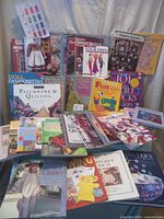 Photo showing a wide spread of sewing and quilting books including doll fashions, patchwork, and kids sewing projects.