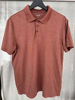 Front view of red heather Old Navy polo shirt on hanger, showing collar, buttons and short sleeves.