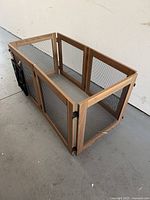 Wooden and metal mesh small animal play pen/cage arranged in a rectangular shape. Shows overall condition and structure.