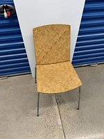 Front view of IKEA Eliot chair showing chevron patterned wooden seat and backrest with metal legs.
