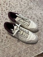 Pair of women's cream and burgundy sneakers from H&M, size 9, showing overall condition and laces tied.
