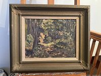 Full view of framed oil painting showing a forest path landscape with trees and foliage.