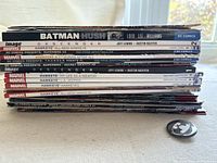 Stack of comic books showing titles and publishers for identification and condition reference.