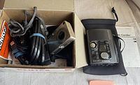 Pentax Optio S4 digital camera, cables, and Sony Walkman Voice-Corder in box and next to box