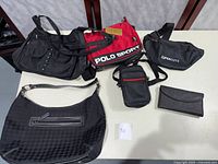 Seven items shown together on a table including handbags and bags