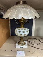 Full view of Fenton glass lamp showing the shell segment scalloped shade, body with raised dot glass design and marble base.