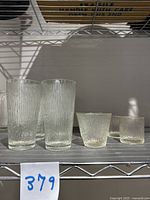 Photo of 4 small textured tumblers showing vertical ribbing pattern, two are taller and two shorter.