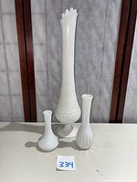 Set of three milk glass vases: tall hobnail Fenton vase in center, two smaller vases flanking sides