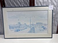 Full view of the framed art print showing the street scene and framing.