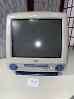 Front view showing 15-inch CRT display, iMac logo, CD-ROM slot and built-in speakers