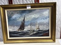 Framing and full view of the vintage oil painting showing sailing ships on the seascape.