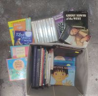 Overall view of all books including both children's and coffee table books, some visible titles like 'Ghost Towns of the West' and boxed set.