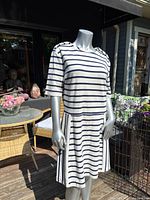 Full view of the Brooks Brothers Red Fleece striped dress on a mannequin outdoors, showing the dropped waist and short sleeves.