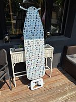 Ironing board front view showing polka dot fabric cover and iron rest