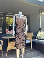 Mannequin wearing the full-length view of the dress outdoors with geometric print visible.