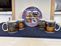 Four ceramic Halloween mugs displayed with original packaging showing mug designs and branding