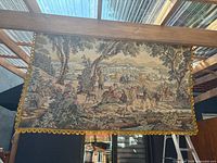 Full view of the vintage tapestry showing the pastoral scene with figures and horses in an outdoor setting.