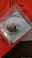 Obverse view of the 2014 Canadian $20 fine silver snowman coin in protective sleeve