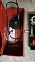 angle grinder inside red metal box